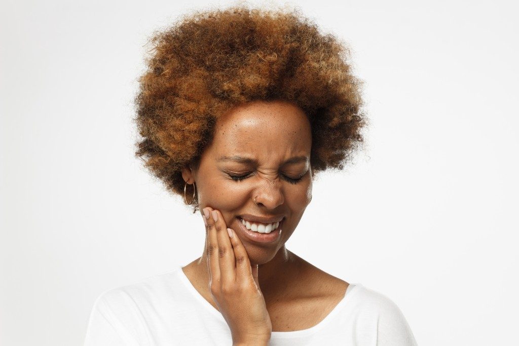 woman reacting to tooth sensitivity