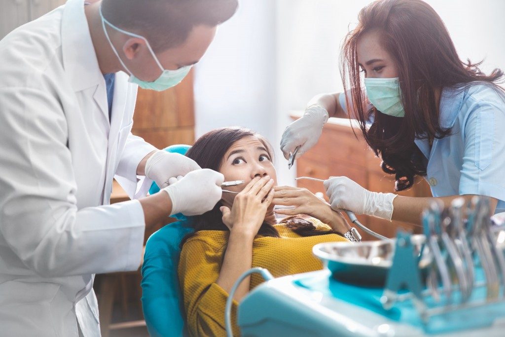 young woman scared of dental treatments