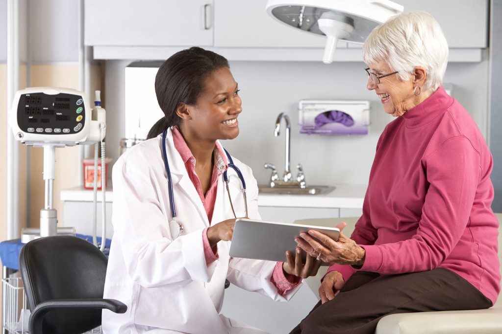 older woman talking to a doctor