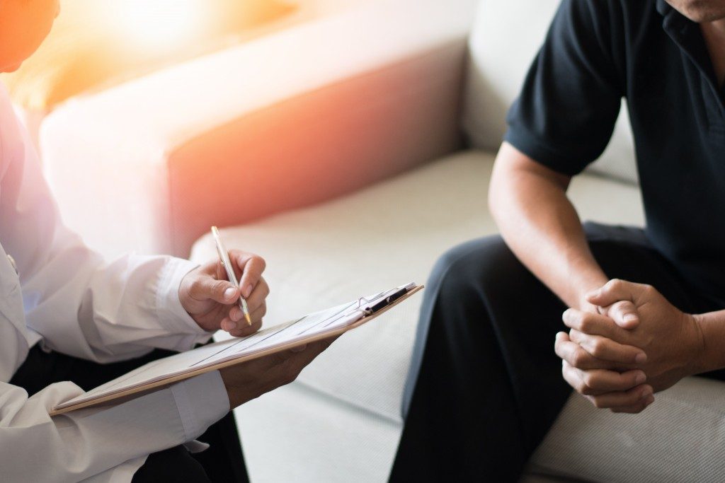 man talking to a doctor