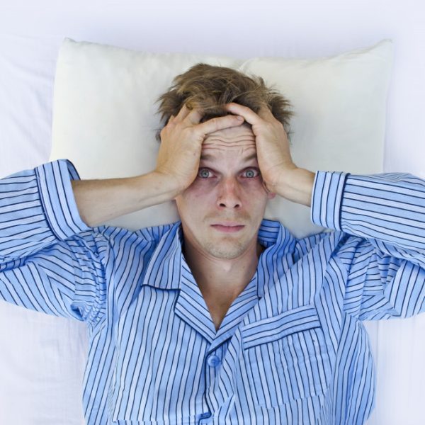 A man stressed after waking up, sleepless night