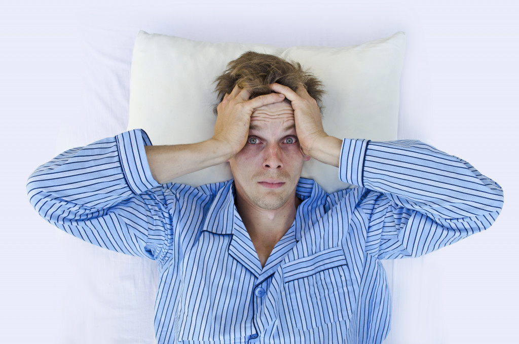 A man stressed after waking up, sleepless night