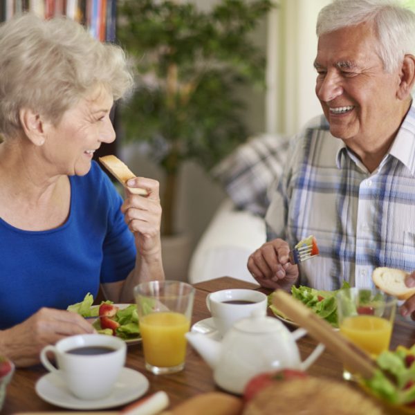senior couple with healthy meal on the table