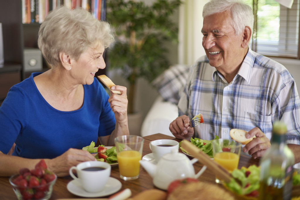senior couple with healthy meal on the table